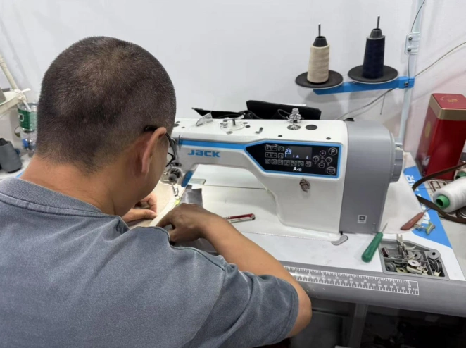 Textile Factory Worker Operating Industrial Sewing Machine for Garment Stitching