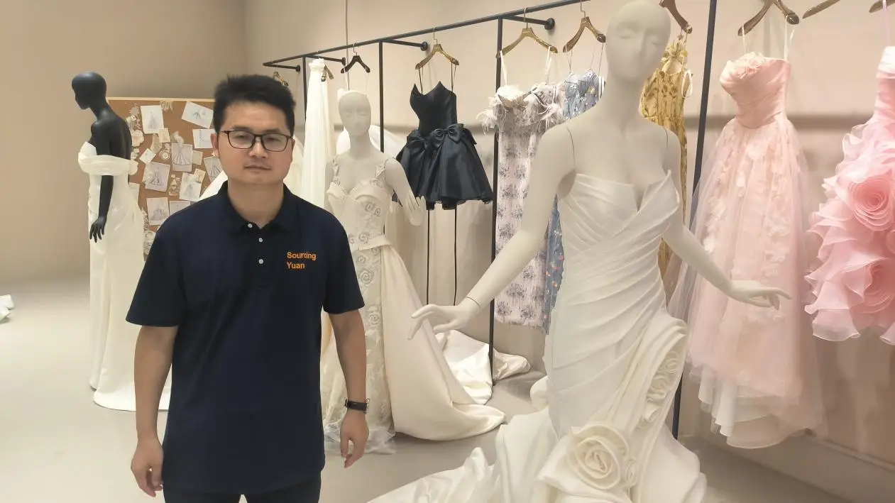 Lee accompanies a client on a tour of the wedding dress factory workshop Accompanying a client on a tour of the wedding dress factory workshop