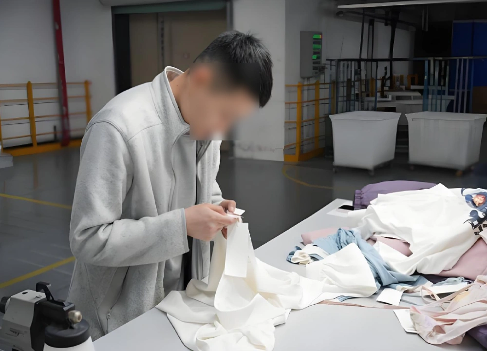 Apparel sourcing inspector checking clothing tags Apparel sourcing inspector checking clothing tags